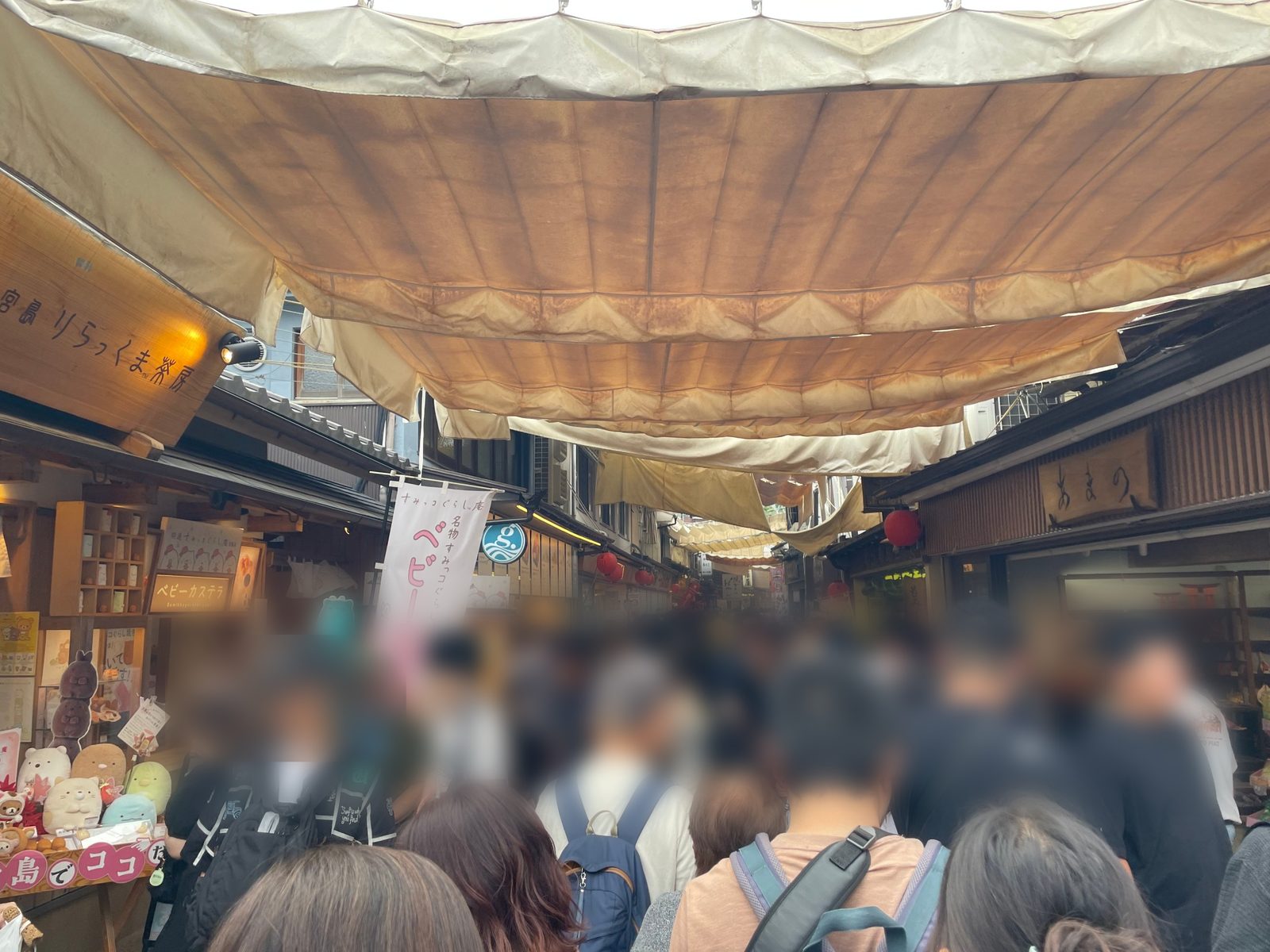 A crowded covered shopping street on Miyajima