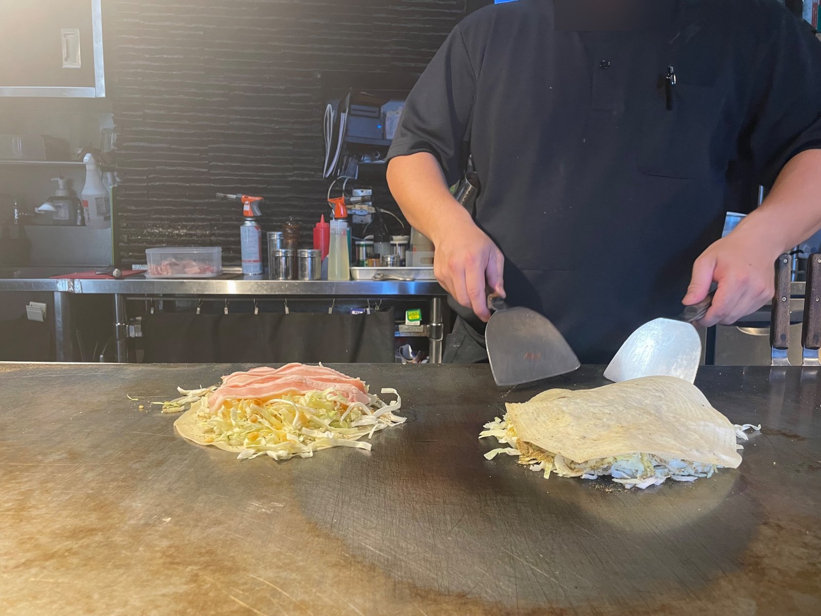Cabbage and pork steaming on the griddle